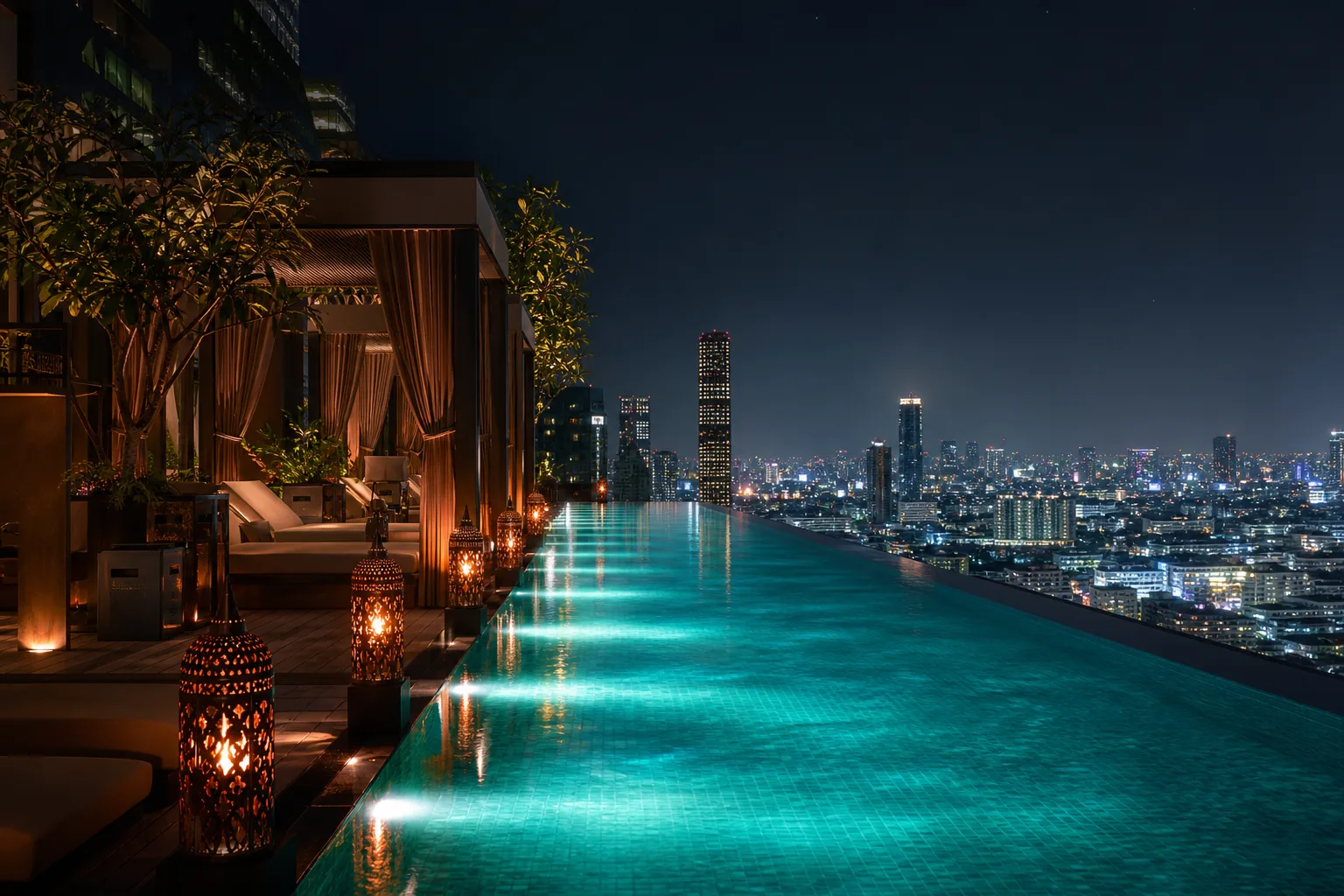 Rooftop infinity pool at night overlooking the city